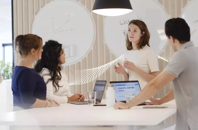 business associates standing around a conference table